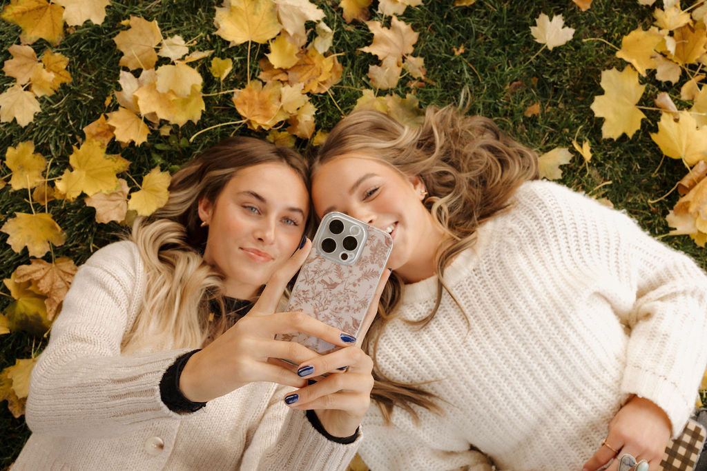 two girls with cute flower phone cases for iphone 14 and iphone 13